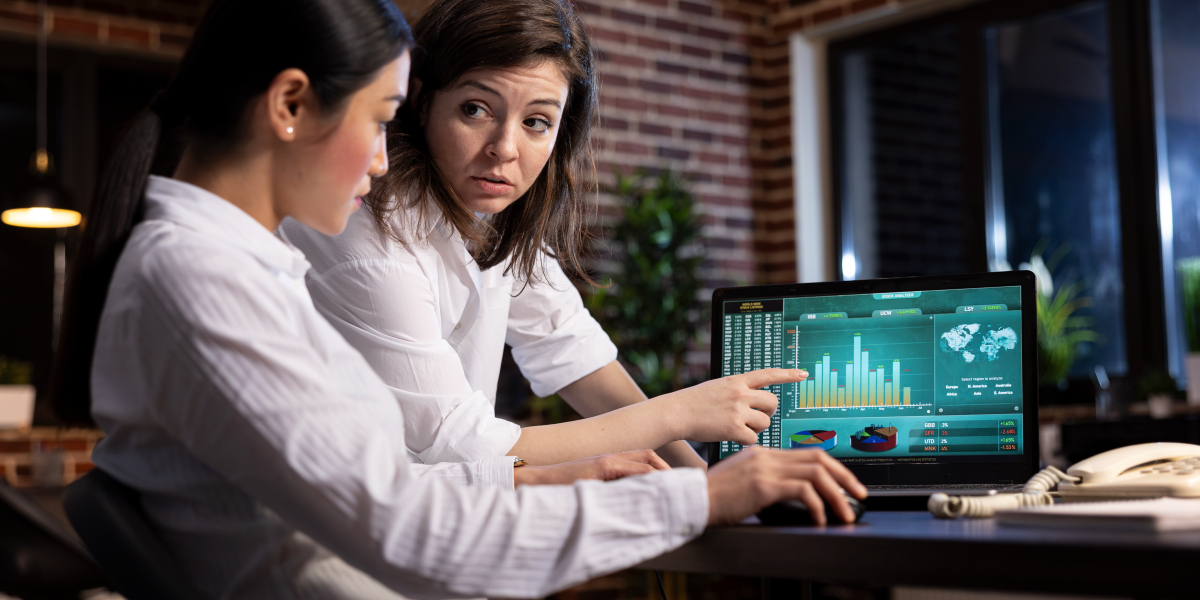 Business professionals analyzing data insights and automation performance on a laptop dashboard